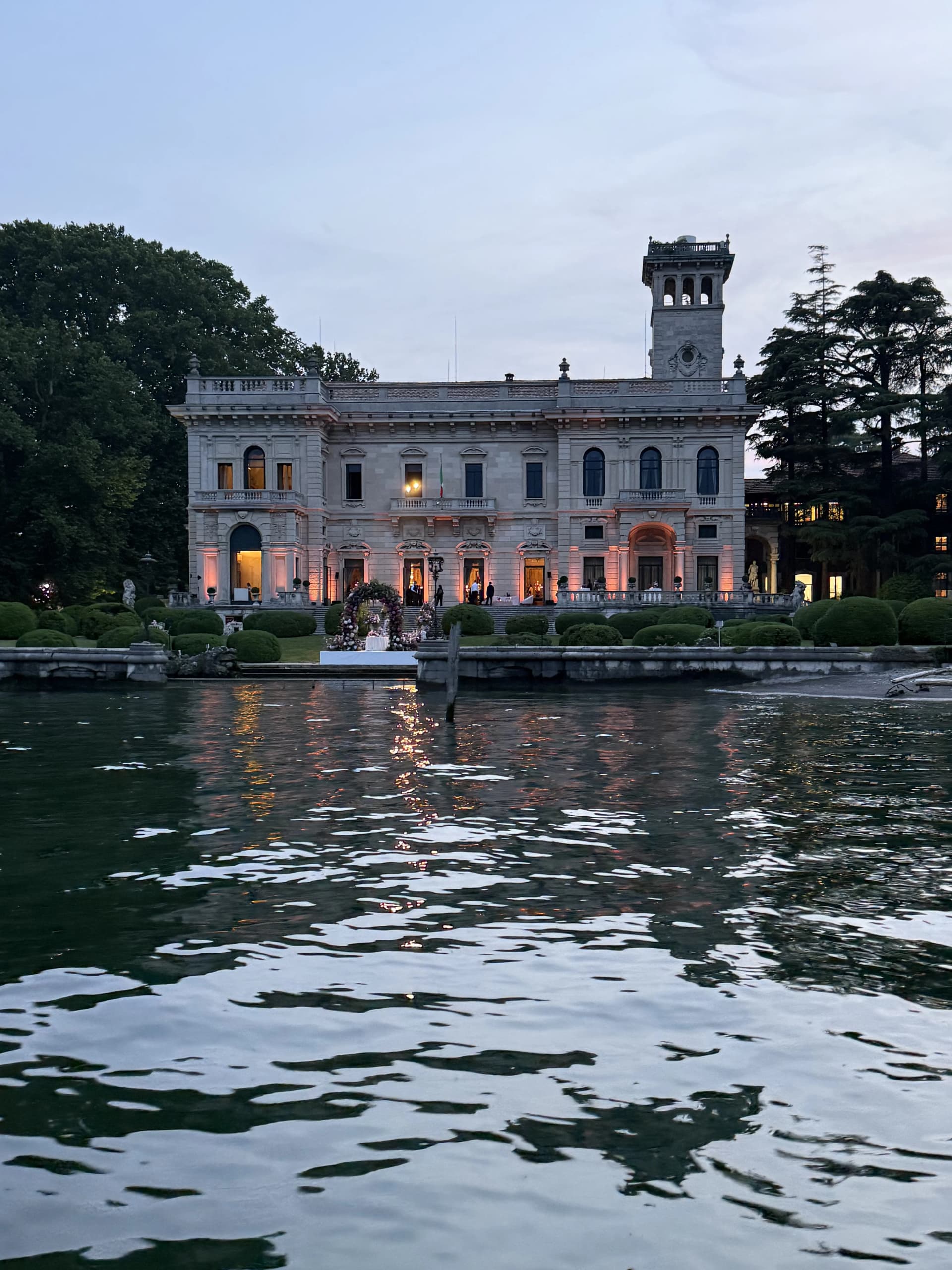 Villa Erba illuminated at sunset seen from the lake