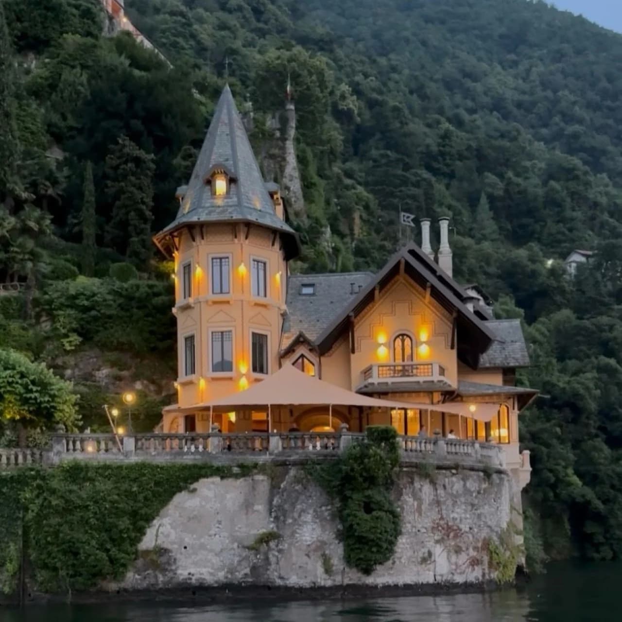 Historic lakeside villa illuminated at dusk on Lake Como